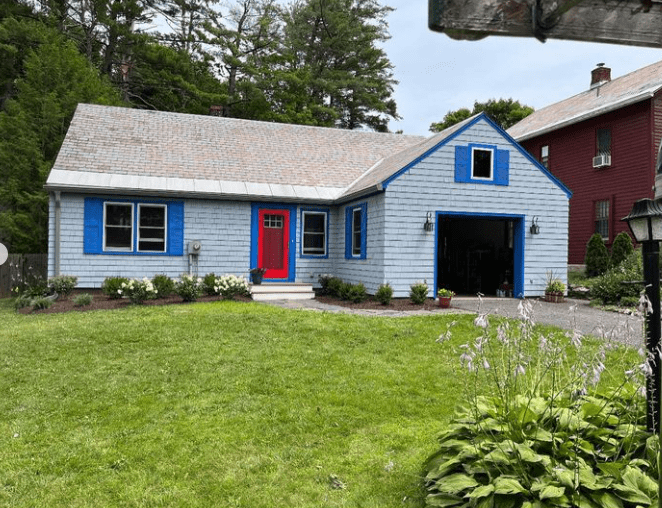 View Of Newly Painted House With Garage